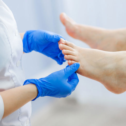 doctor inspecting toes