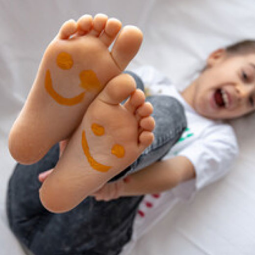 smile painted on kid feet